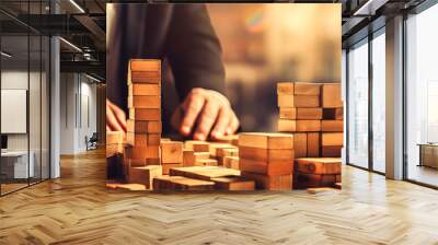 Businessman Building Wooden Blocks: Success Amid a Blurred Business Landscape. Wall mural