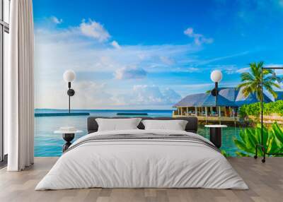 Beautiful water villas in tropical Maldives island at the sunris Wall mural