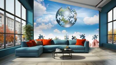 Business concept with a hand building puzzle globe Wall mural