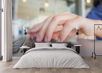 Closeup of business woman hand typing on laptop keyboard with mo Wall mural