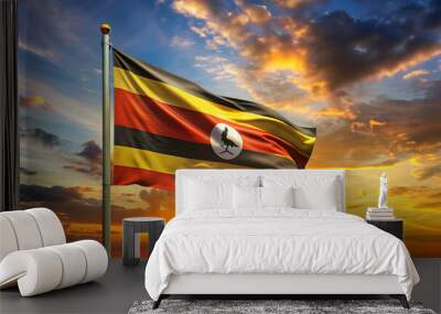 Uganda flag waving proudly against a vibrant sunset sky, Uganda, flag, sunset, national holiday, pride, patriotism Wall mural