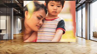 morning time, adorable 2 years old asian little boy and mother is watering the plant in the pots out Wall mural