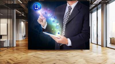 Businessman holding tablet with pressing smartphone icon button. internet and networking concept Wall mural