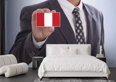 Businessman in suit hand holding a business card with Peru Flag Wall mural