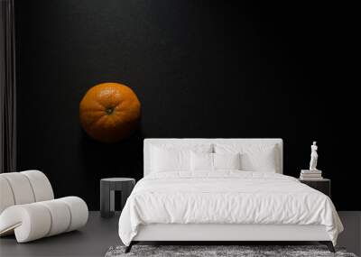 Top view of an orange isolated on a black background Wall mural