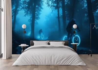 Two cyclists ride through a foggy forest at night with glowing wheels. Wall mural