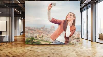 Beautiful young woman making a picture with background of Floren Wall mural