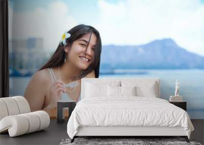 Biracial young woman eating Hawaiian BBQ,  Diamond Head in background Wall mural