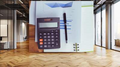 Top view of the businessman's work, calculator placed on the table. Wall mural