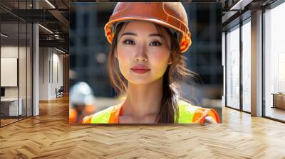 A beautiful Japanese woman wearing an orange and yellow vest, with long hair tied in a single ponytail, is posing for the camera at a construction site Wall mural