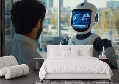 A man and a robot are standing in front of a monitor. The robot is white and has a blue face. The man is wearing a suit and tie. The robot is talking to the man Wall mural