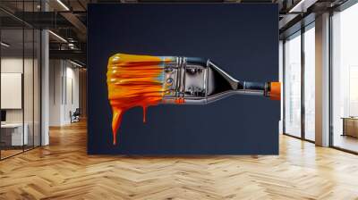 Paint brush dipped in orange paint on clean dark blue background Wall mural