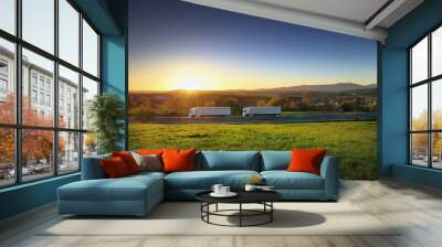 Two white trucks transport on the road at sunset and cargo Wall mural