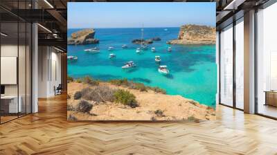 Boats anchored in small cove Blue lagoon on Comino island in Malta. Turquoise sea, azure ocean, yachts and sailing boats. Panorama view on bay with crytal clear water. Wall mural