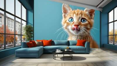 Portrait of a hungry kitten with beautiful blue eyes licking its lips and gazing ahead. Wall mural