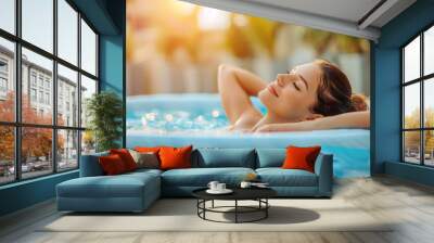 Young woman relaxing in outdoor spa swimming pool.Beauty and body care Wall mural