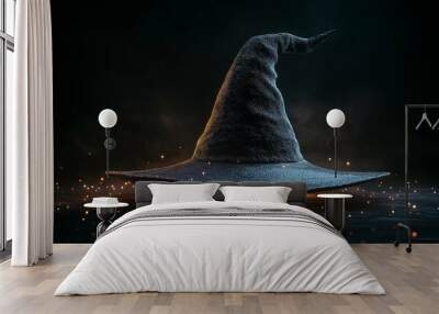 Simple witch hat on a black background with a subtle glow around the edges. Wall mural