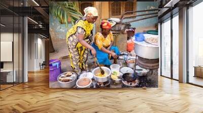 African woman cooking traditional food at street Wall mural