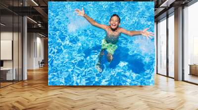 Happy children on summer vacation swimming pool having fun and h Wall mural