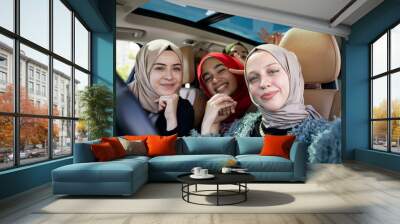 Muslim female friends enjoying road trip traveling at vacation in the car. High quality photo Wall mural