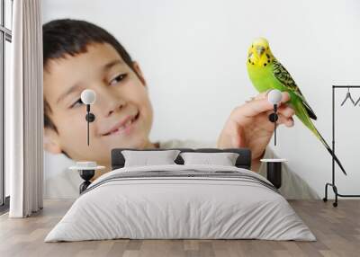 Portrait of a kid girl with her domestic parrot Wall mural