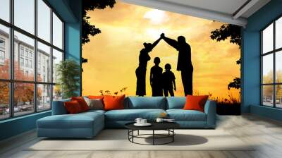 Silhouette, group of happy children playing on meadow, sunset, s Wall mural