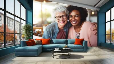  Happy smiling middle aged female friends sitting in a café laughing and giving support each other. They are celebrate a long friendship Wall mural