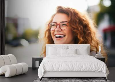  Portrait of happy young woman wearing glasses outdoors Wall mural