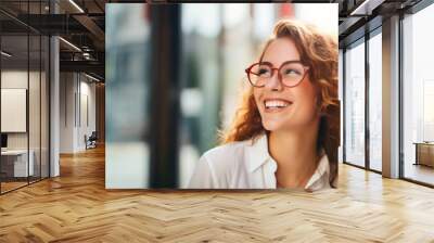  Portrait of happy young woman wearing glasses outdoors Wall mural