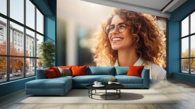  Portrait of happy young woman wearing glasses outdoors Wall mural