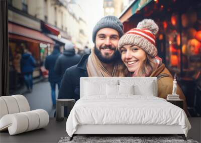 A young cheerful couple having fun in Paris, Enjoying Christmas Market Wall mural