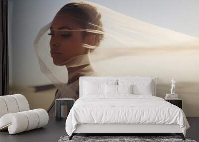 Beautiful woman covered in a soft white lace material that sways in the wind, walks in the desert in Dubai Wall mural