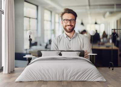 Confident and smiling handsome hipster man standing in the office	 Wall mural