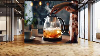 Female hands pouring boiling water from a modern kettle for brewing tea in the kitchen at home

 Wall mural