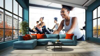 Group fitness class , featuring participants engaged in an energetic workout, such as spinning, aerobics, set against a bright, gym studio background Wall mural