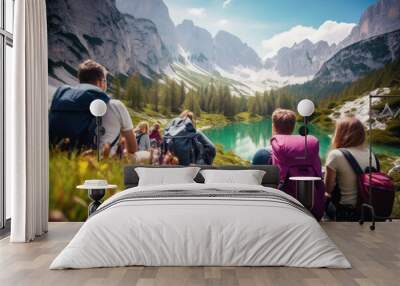 Group of backpackers sitting and resting while climbing to the Julian Alps, surrounded by beautiful nature. Travel, backpacking and active lifestyle concept.   Wall mural