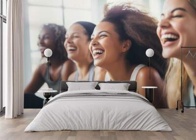 Group of young women smiling during yoga or pilates exercise in yoga hall Wall mural