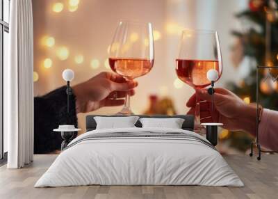 Happy couple toasting with glasses of rose wine celebrating holidays, beautiful Christmas table setting and decoration in the background Wall mural