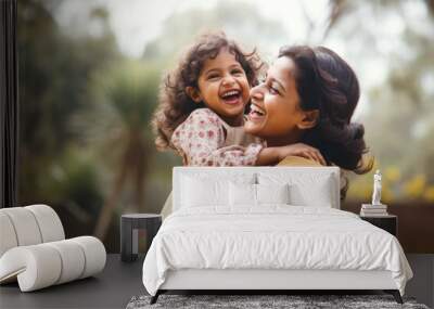 Happy Indian mother having fun with her daughter outdoor. Family and love concept  Wall mural