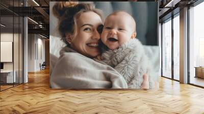 happy mom holding her cute smiling baby in the cozy bedroom Wall mural