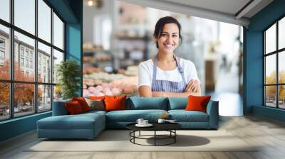 Happy small pastry shop owner, smiling proudly at her store. Cheerful female baker working at her shop Wall mural