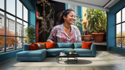 Happy smiling Hispanic woman in the backyard of her house in Mexico  Wall mural