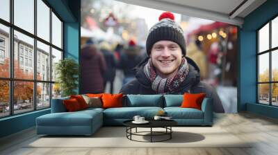 Happy smiling young man in winter clothes at street Christmas in Toronto Wall mural