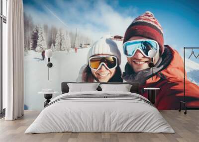 Happy young couple with sunglasses and ski equipment in ski resort Bukovel, having fun and taking selfie, winter holiday concept Wall mural