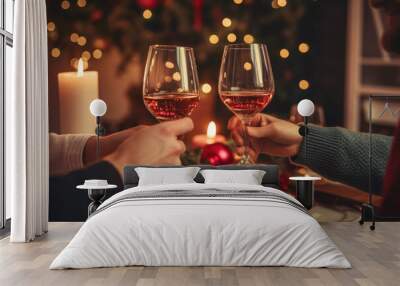 People toasting with glasses of rose wine celebrating holidays, beautiful Christmas table setting and decoration in the background Wall mural