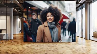 Portrait of a beautiful young black woman standing on the city street, winter time Wall mural