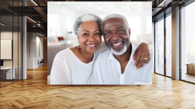 Portrait of a happy, smiling black senior couple at family gathering indoors Wall mural