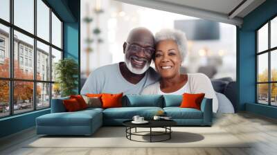 Portrait of a happy, smiling black senior couple at family gathering indoors Wall mural