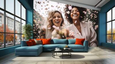 Portrait of a happy smiling lesbian couple celebrating their wedding with lots of confetti flying around them. Diversity, sexual equality, and same-sex marriage concept Wall mural