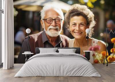 Portrait of a happy smiling senior couple at family gathering outdoors  Wall mural